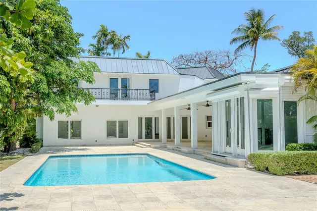 a view of a house with swimming pool and sitting area