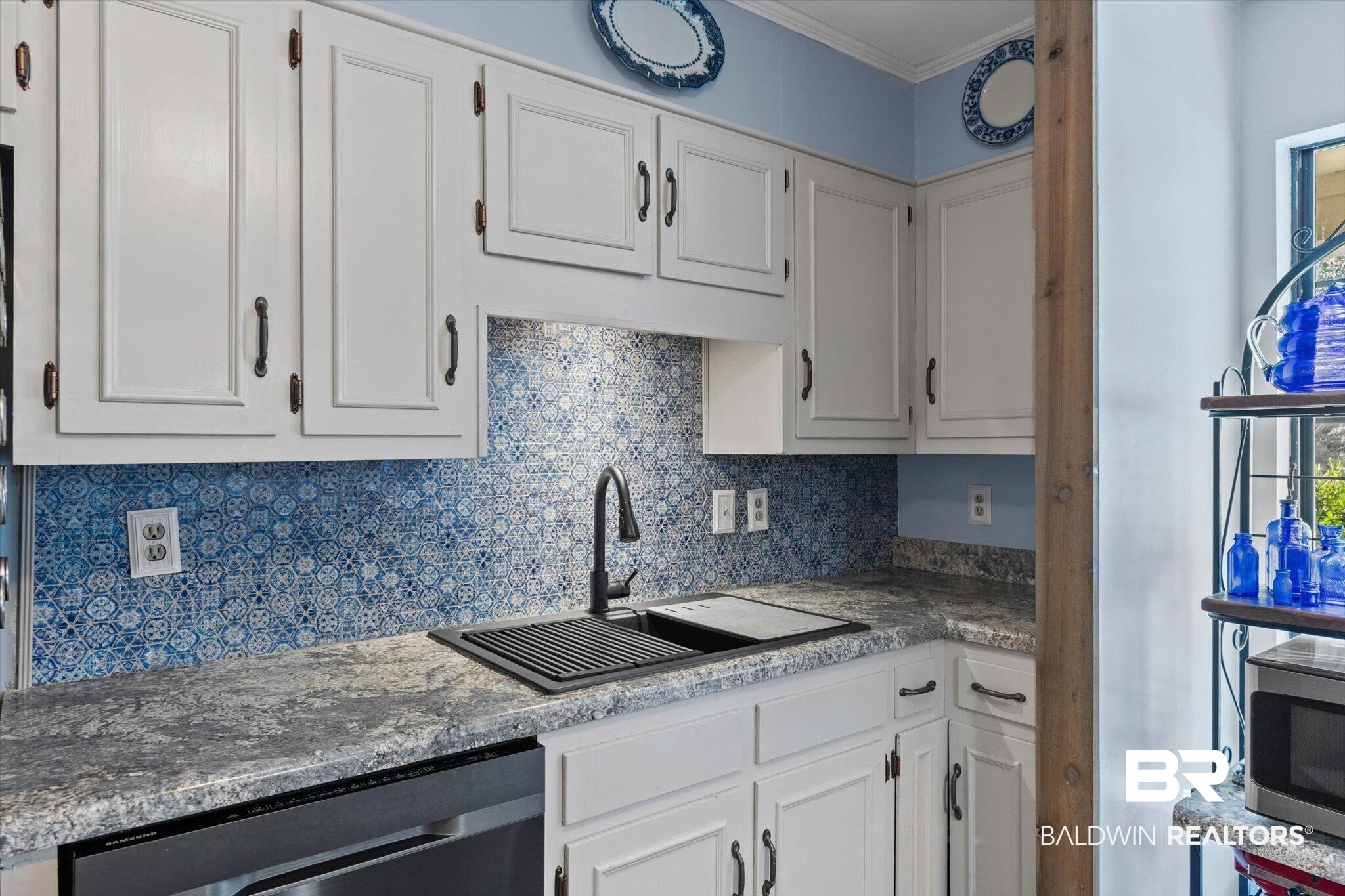 3846 Leslie Road Saraland, AL 36571 - Photo 11 of 40 Kitchen with white cabinets, tasteful backsplash, appliances with stainless steel finishes, ornamental molding, and dark countertops