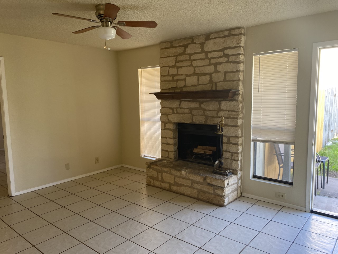 110 Verna Spur, Unit A Georgetown, TX 78628 - Photo 8 of 8 A stone-clad fireplace creates a focal point in this cozy living area, offering a warm gathering space.