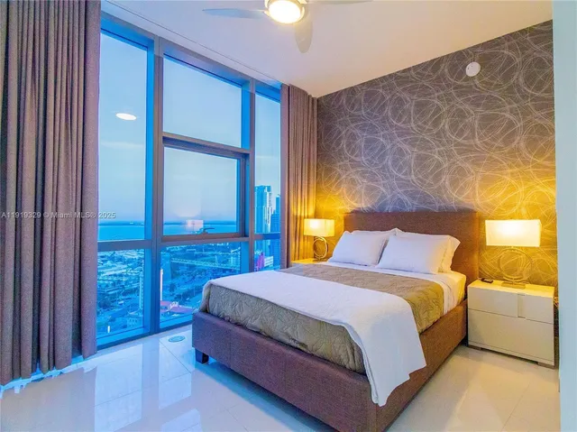 a bedroom with a bed and a night stand