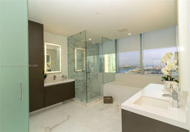 a bathroom with a tub sink shower and mirror