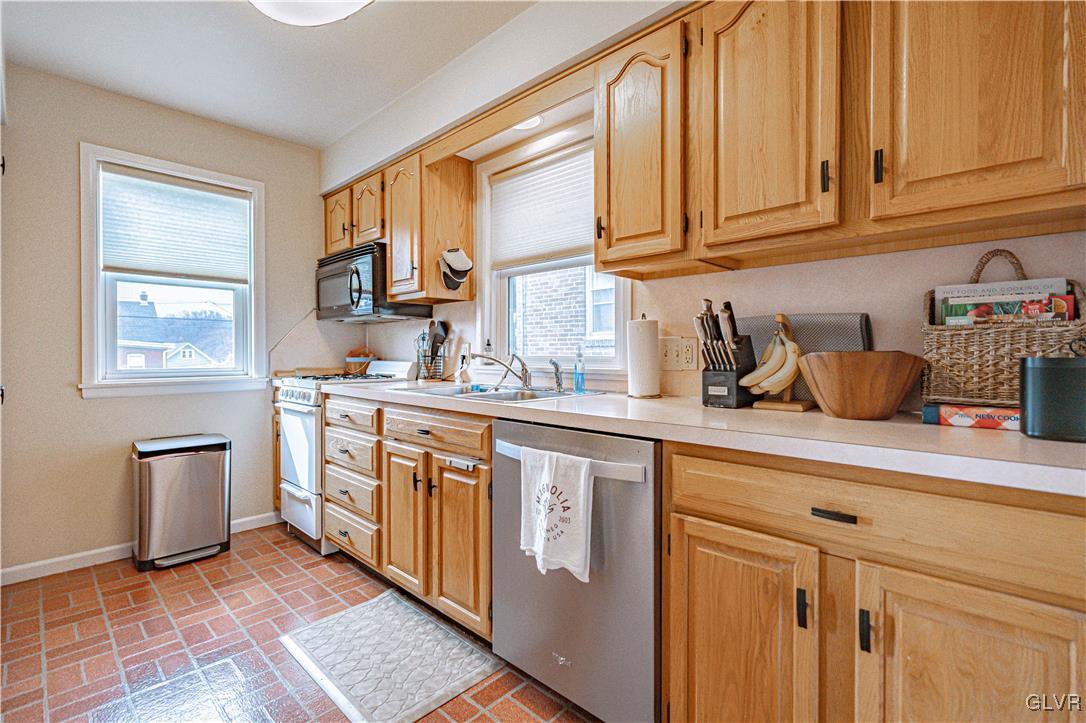 711 Spring Street Bethlehem, PA 18018 - Photo 13 of 26 a kitchen with stainless steel appliances granite countertop a sink stove and cabinets