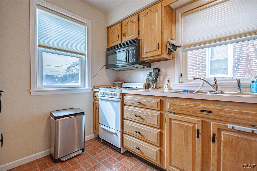 711 Spring Street Bethlehem, PA 18018 - Photo 14 of 26 a kitchen with cabinets stainless steel appliances a sink and a window
