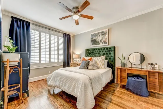 a bedroom with bed and wooden floor