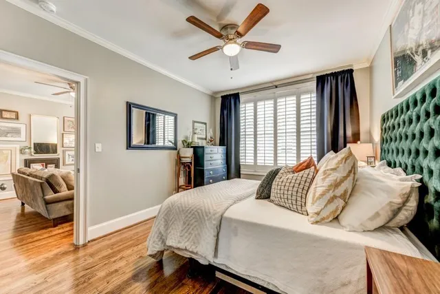 a bedroom with a large bed and a chandelier
