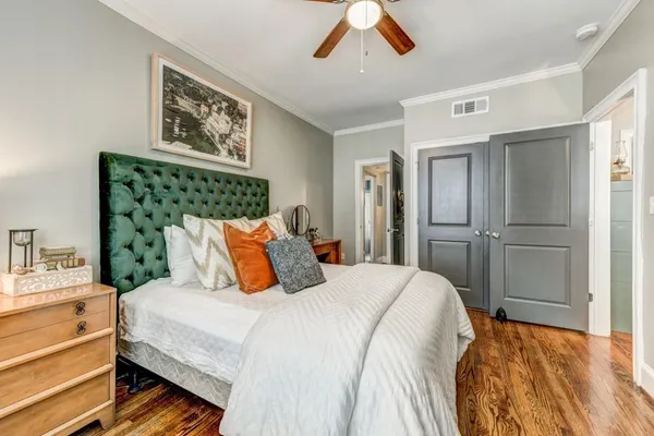 a bedroom with a bed and a chandelier