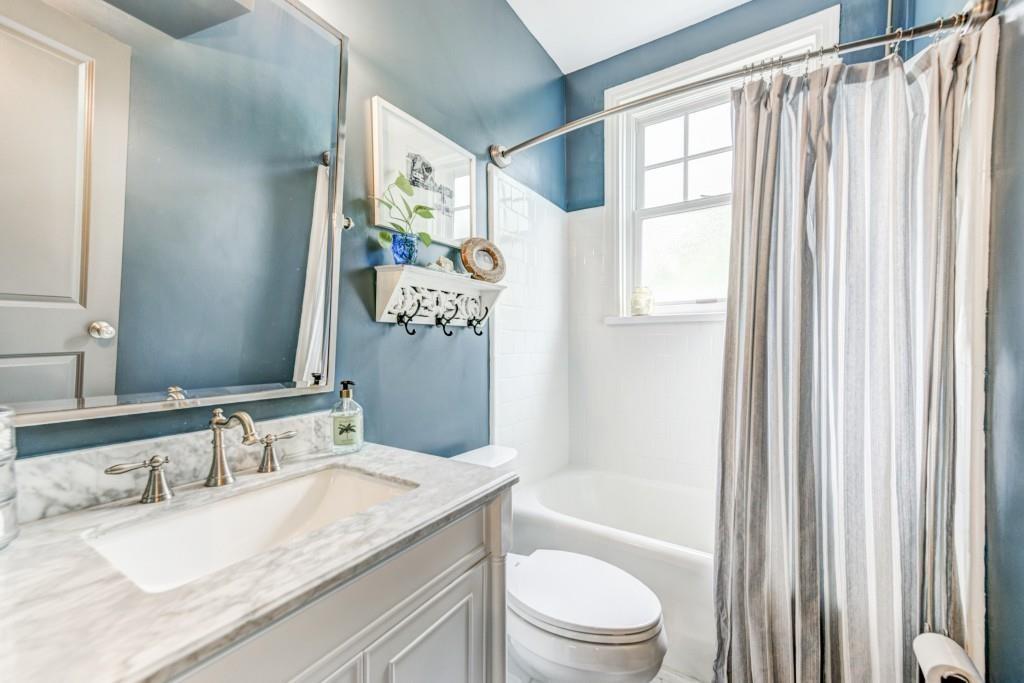 28 Collier Road Northwest, Unit 11 Atlanta, GA 30309 - Photo 15 of 23 a bathroom with a granite countertop sink a toilet and a bathtub