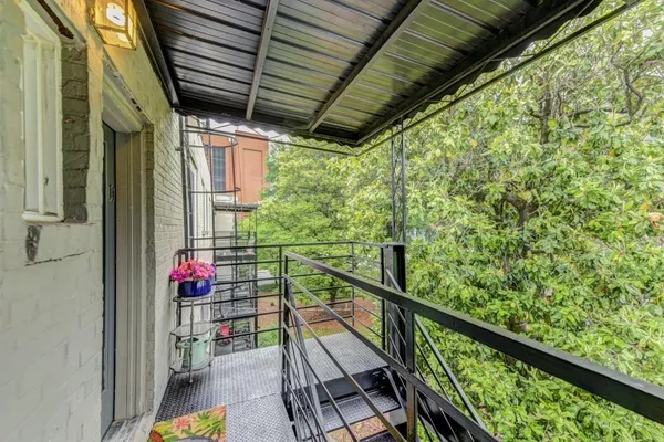 a view of a chair and table in backyard of the house