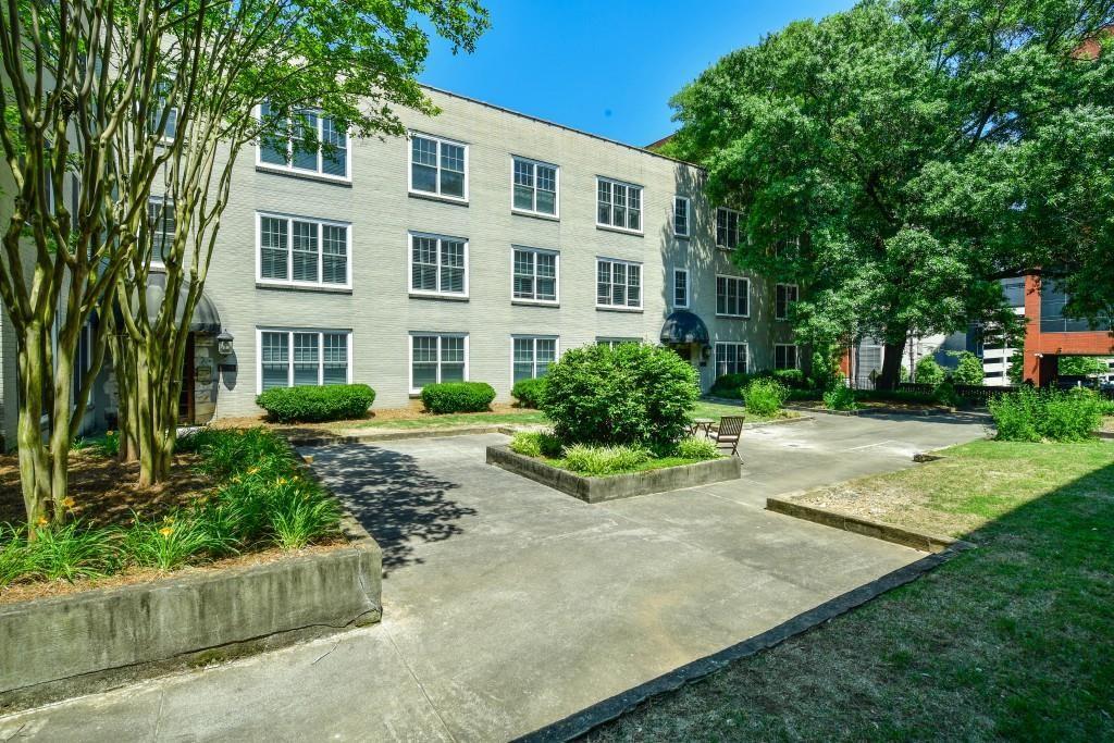 28 Collier Road Northwest, Unit 11 Atlanta, GA 30309 - Photo 20 of 23 front view of a building with a yard