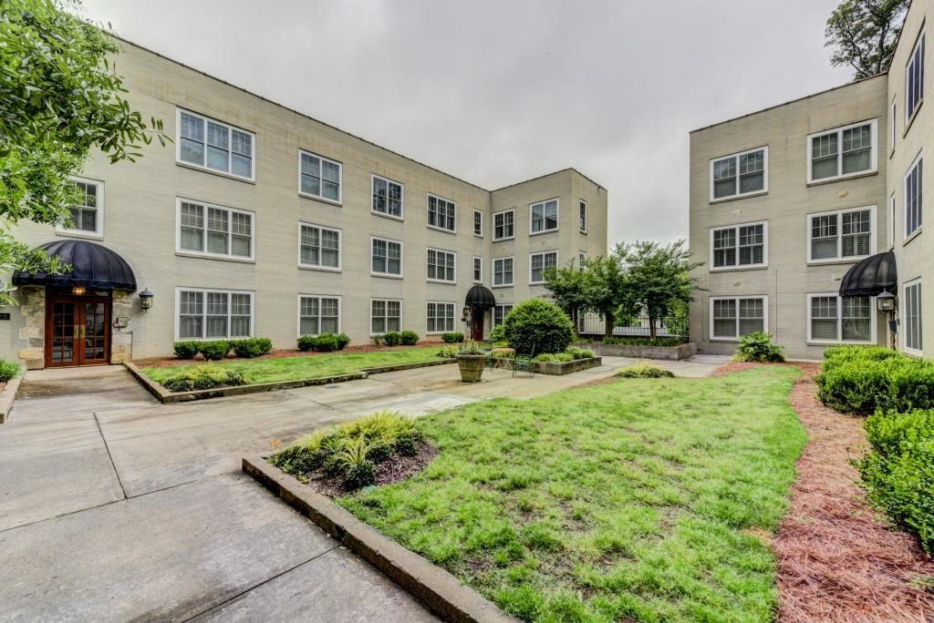 28 Collier Road Northwest, Unit 11 Atlanta, GA 30309 - Photo 22 of 23 a front view of a building with garden
