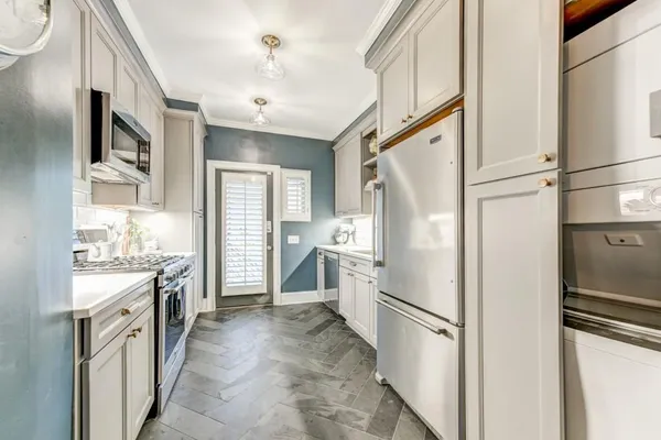 a kitchen with a refrigerator a sink and dishwasher