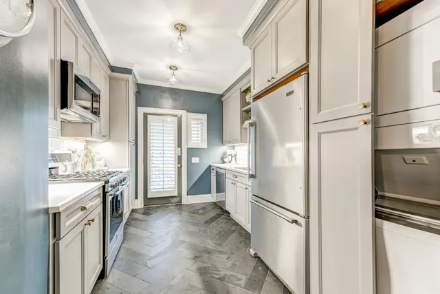 a kitchen with a refrigerator a sink and dishwasher