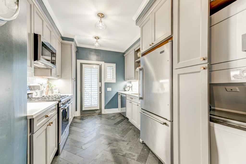 28 Collier Road Northwest, Unit 11 Atlanta, GA 30309 - Photo 6 of 23 a kitchen with a refrigerator a sink and dishwasher