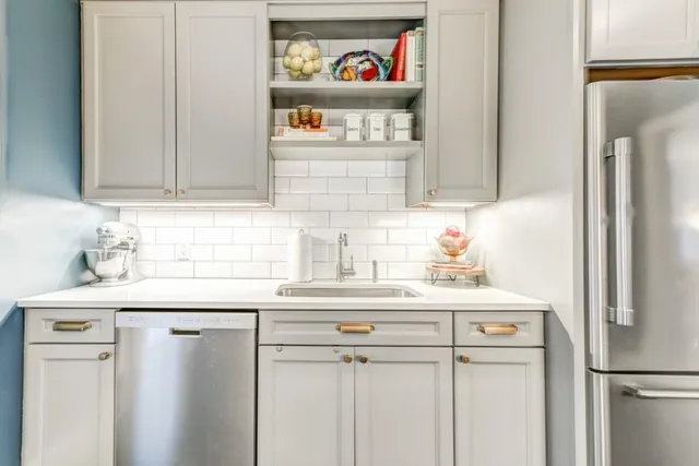 a kitchen with stainless steel appliances a refrigerator and a sink