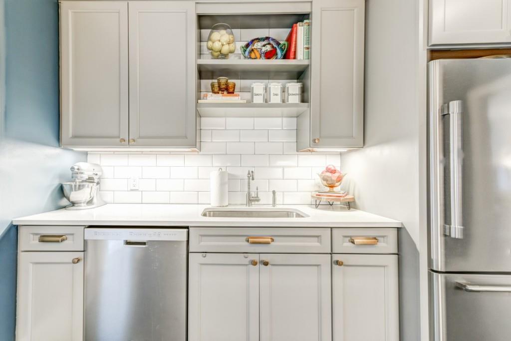 28 Collier Road Northwest, Unit 11 Atlanta, GA 30309 - Photo 8 of 23 a kitchen with stainless steel appliances a refrigerator and a sink