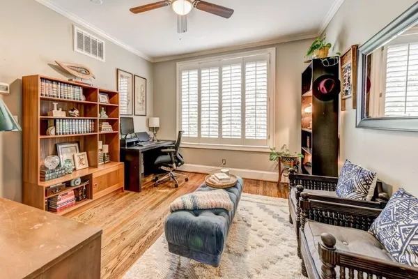 a living room with furniture and a book shelf