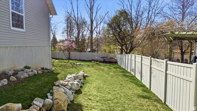 353 Robin Street Smithfield, UT 84335 - Photo 54 of 70 Fenced backyard with a trampoline