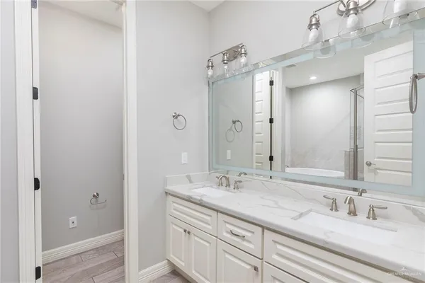 a bathroom with a double vanity sink and a mirror