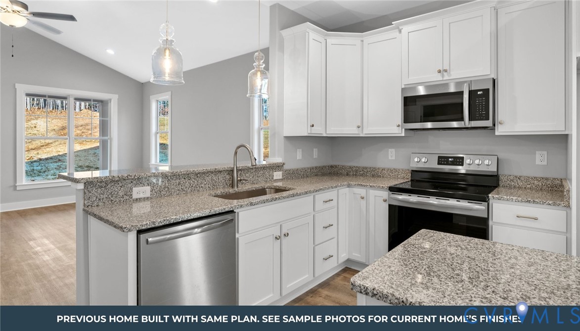 435 Raleigh Avenue South Hill, VA 23970 - Photo 4 of 11 a kitchen with stainless steel appliances granite countertop a stove a sink and a microwave