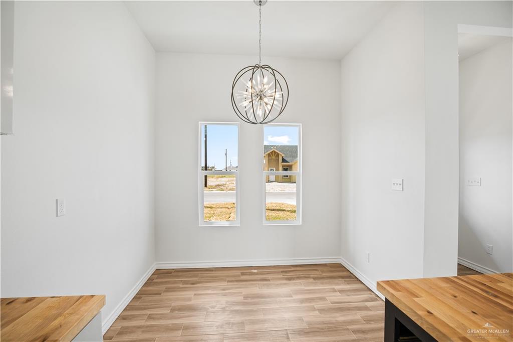 2317 Tuscany Road Weslaco, TX 78596 - Photo 4 of 13 a view of an entryway with wooden floor