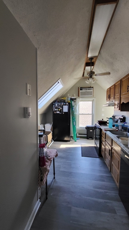 118 Gershom Avenue, Unit 3 Lowell, MA 01854 - Photo 3 of 9 a view of a kitchen with a sink cabinets and wooden floor