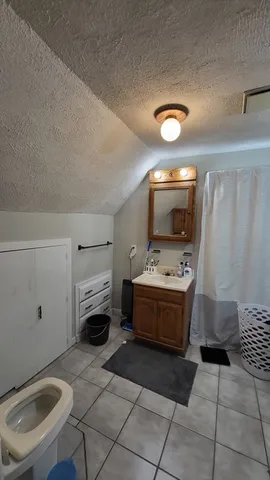 a room with a washing machine and a fireplace