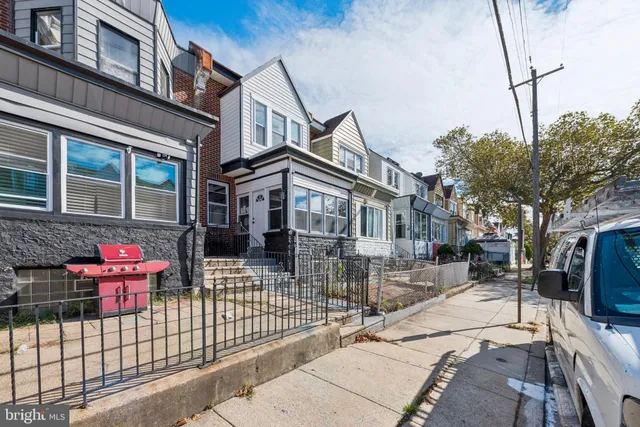 a view of a house with a wooden fence