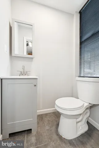 a bathroom with a sink toilet and mirror