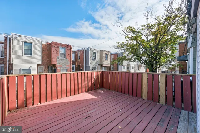 a balcony with wooden floor and fence