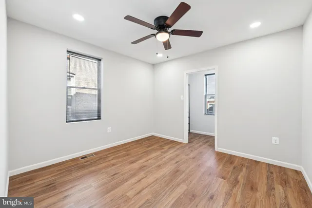 wooden floor in an empty room with a window