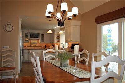 55 Ruggles Road Orleans, MA 02653 - Photo 10 of 30 a view of a dining room with furniture a chandelier and large windows