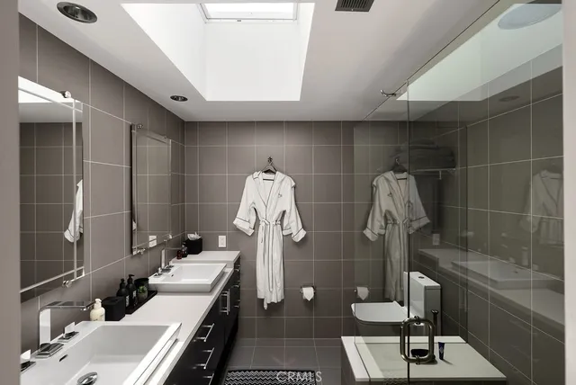 a bathroom with a double vanity sink and a mirror