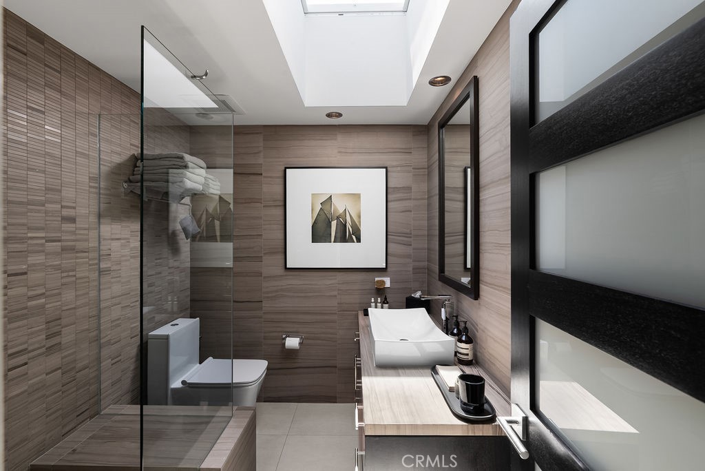 1585 South Coast Highway, Unit 66 Laguna Beach, CA 92651 - Photo 13 of 18 a bathroom with a toilet sink and mirror