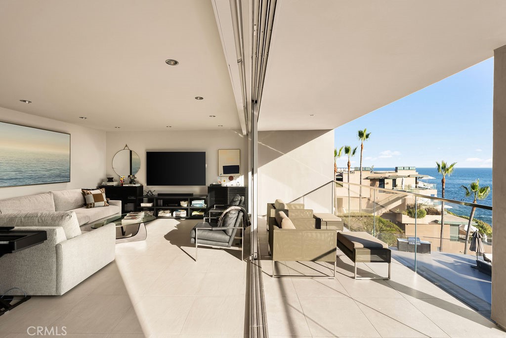 1585 South Coast Highway, Unit 66 Laguna Beach, CA 92651 - Photo 4 of 18 a living room with lots of furniture and a flat screen tv