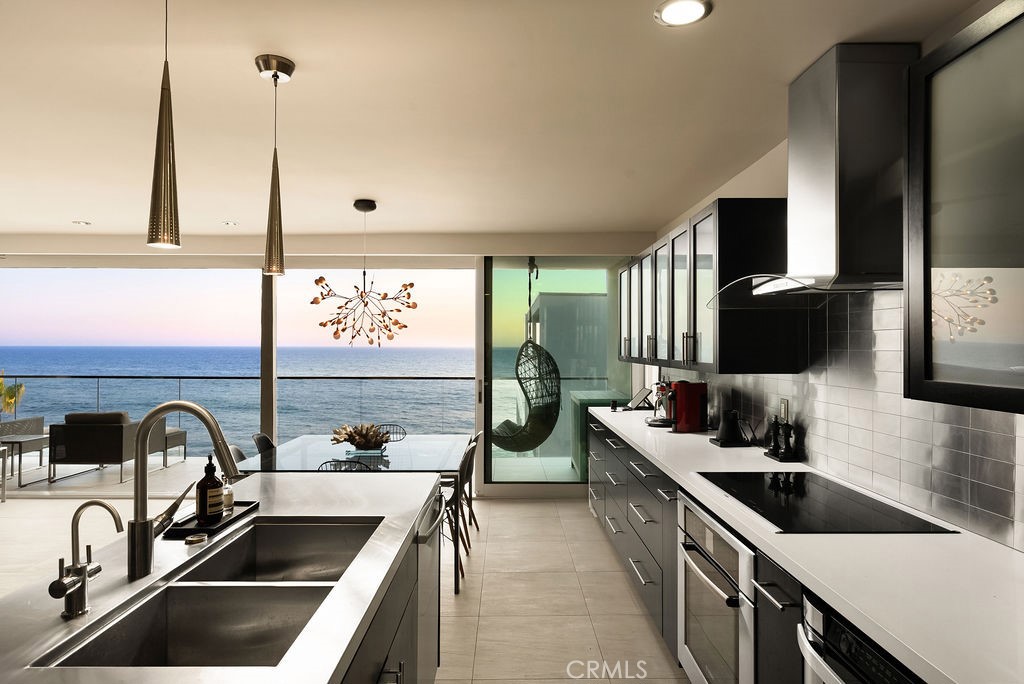 1585 South Coast Highway, Unit 66 Laguna Beach, CA 92651 - Photo 6 of 18 a kitchen that has a sink and a stove