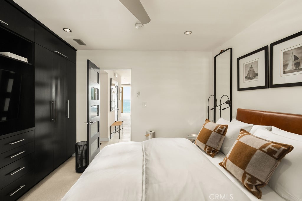 1585 South Coast Highway, Unit 66 Laguna Beach, CA 92651 - Photo 10 of 18 a bedroom with a bed and wooden floor