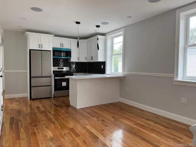 a kitchen with stainless steel appliances a refrigerator sink and cabinets