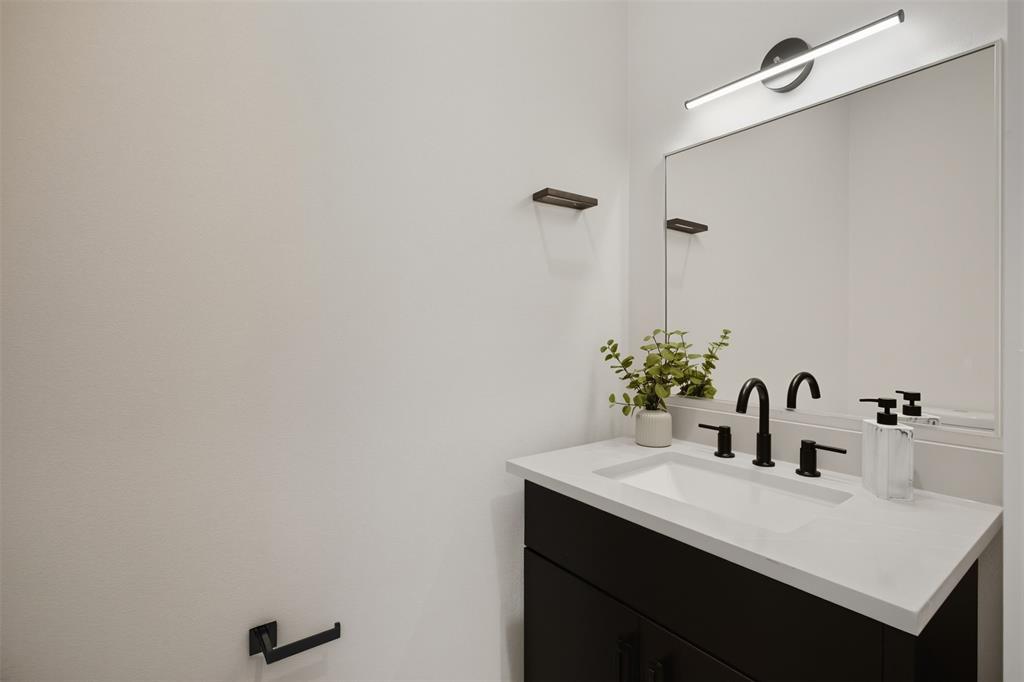 4517 Munger Avenue, Unit 101 Dallas, TX 75204 - Photo 33 of 39 a bathroom with a sink and a mirror