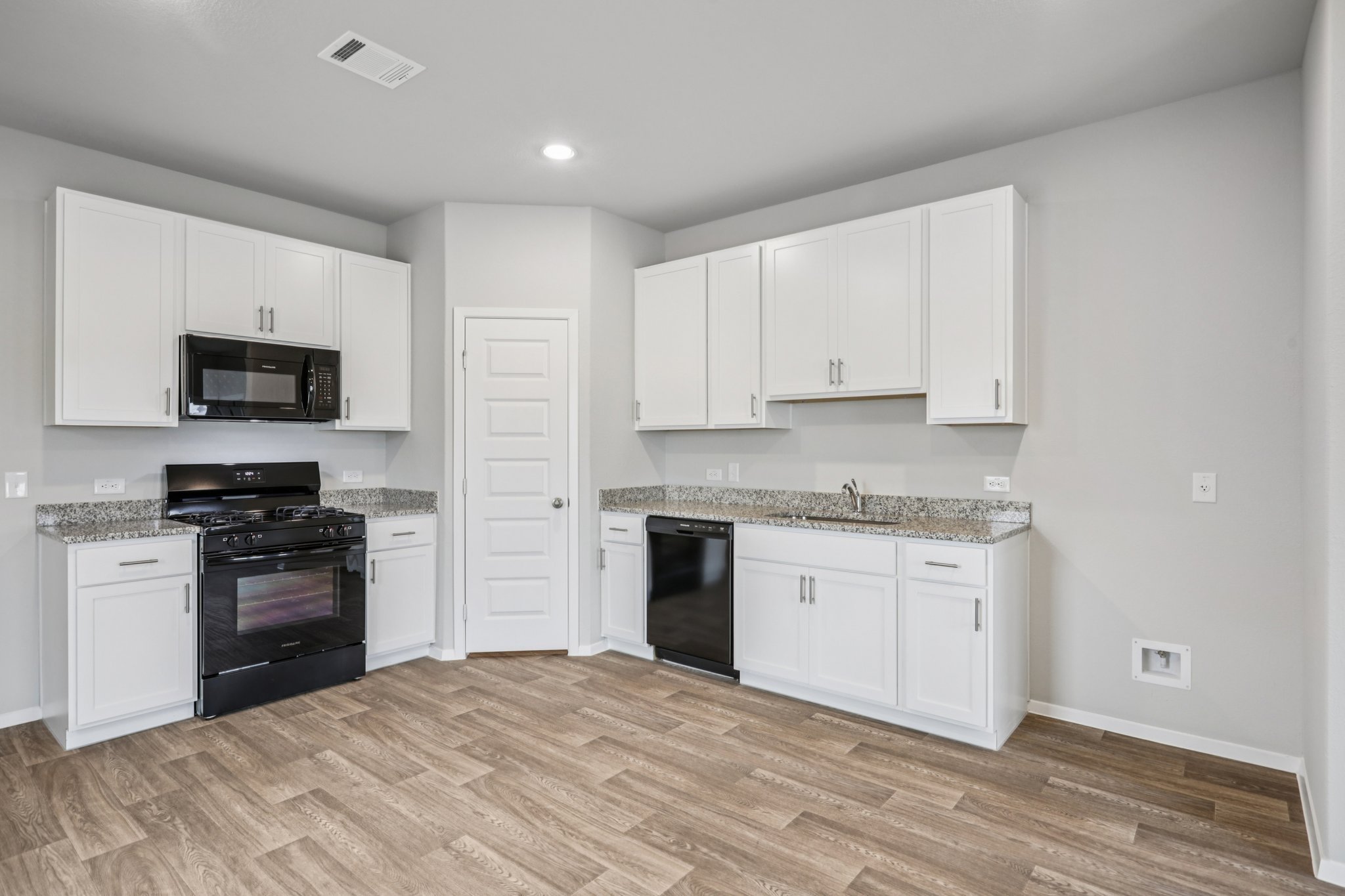 104 Summer Drive Elgin, TX 78621 - Photo 8 of 40 a kitchen with granite countertop a stove top oven sink and cabinets