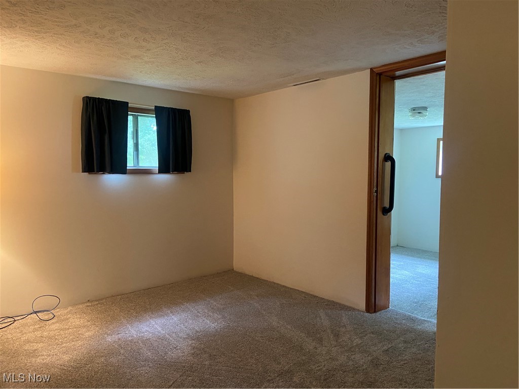 14092 Hatfield Road Rittman, OH 44270 - Photo 21 of 38 Bedroom with carpet floors and a textured ceiling