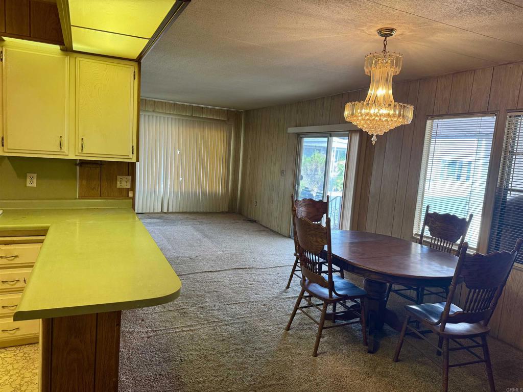 8301 Mission Gorge Road, Unit 54 Santee, CA 92071 - Photo 11 of 24 a dining room with a table chairs and a chandelier