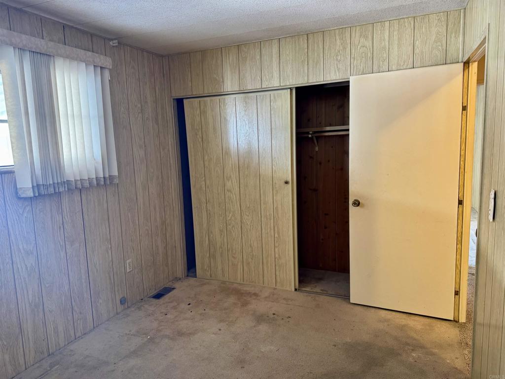 8301 Mission Gorge Road, Unit 54 Santee, CA 92071 - Photo 15 of 24 a view of an empty room with a wooden door