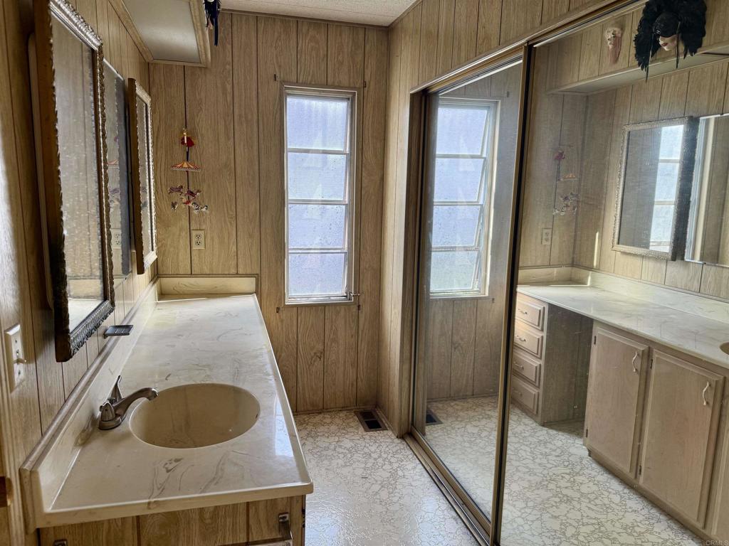 8301 Mission Gorge Road, Unit 54 Santee, CA 92071 - Photo 21 of 24 a bathroom with a granite countertop sink and a mirror