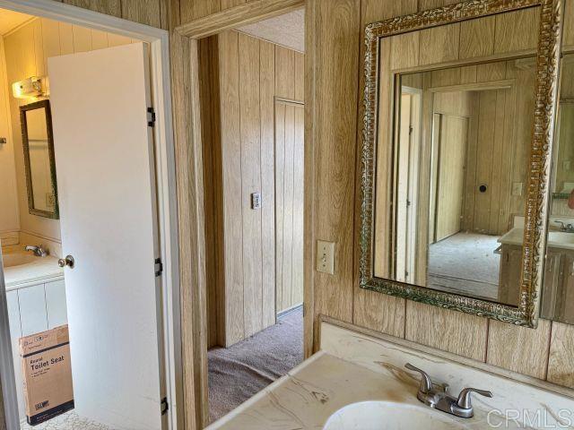 8301 Mission Gorge Road, Unit 54 Santee, CA 92071 - Photo 22 of 24 a en suite bathroom with a granite countertop sink and a mirror