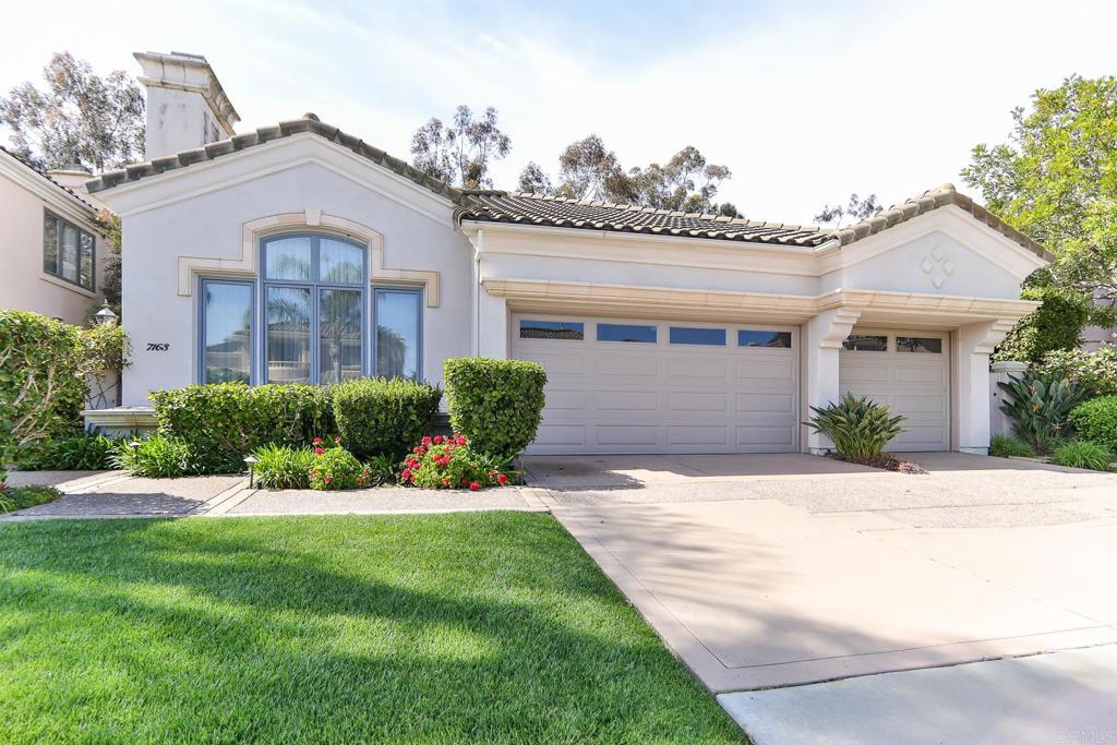 7163 Tern Place Carlsbad, CA 92011 - Photo 3 of 48 a front view of a house with a yard and potted plants
