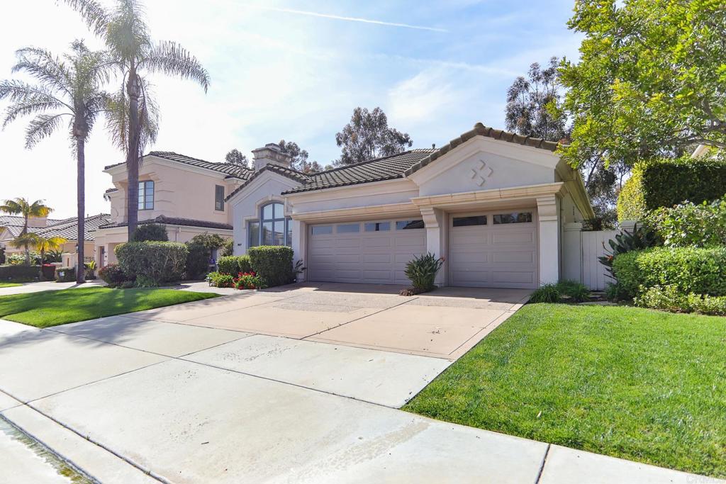 7163 Tern Place Carlsbad, CA 92011 - Photo 4 of 48 a front view of a house with a yard and garage