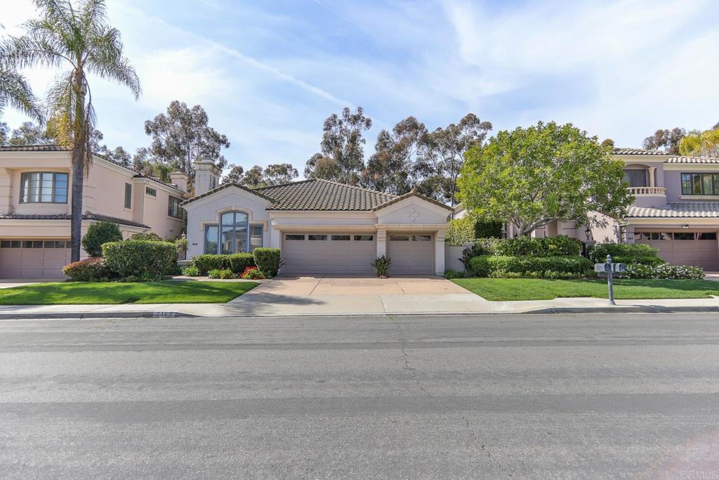 7163 Tern Place Carlsbad, CA 92011 - Photo 5 of 48 a front view of a house with a yard and a garage