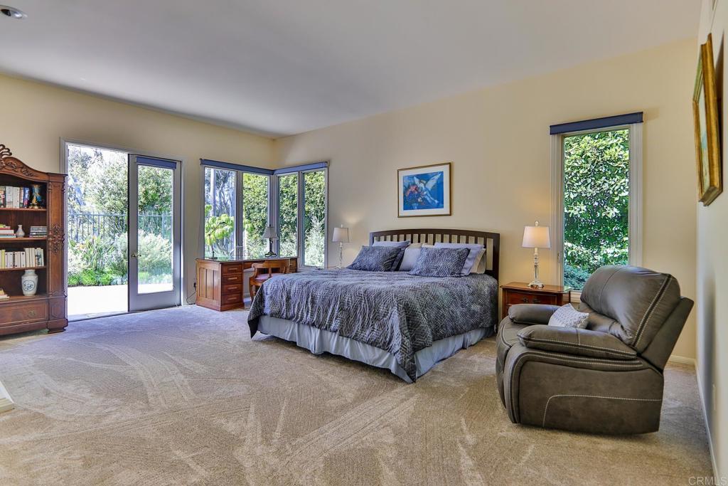 7163 Tern Place Carlsbad, CA 92011 - Photo 7 of 48 a spacious bedroom with a bed and a couch next to a window