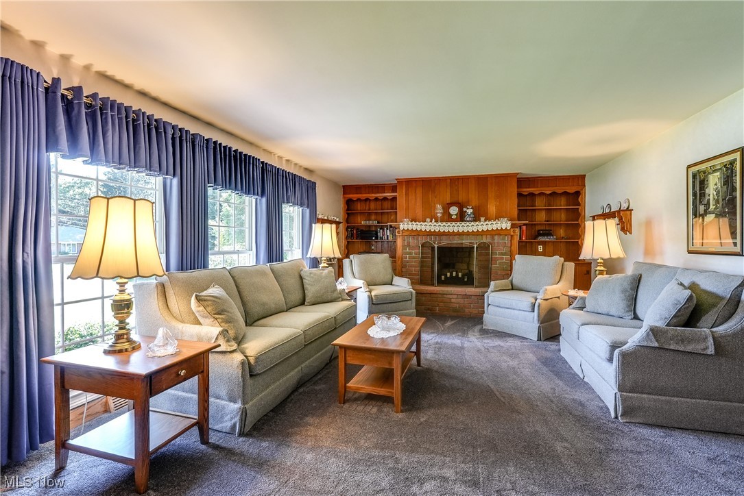 330 Ormsby Road Akron, OH 44333 - Photo 6 of 29 Carpeted living room featuring a fireplace and built in features