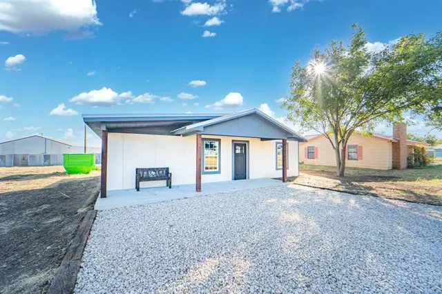 a view of a house with a yard and garage
